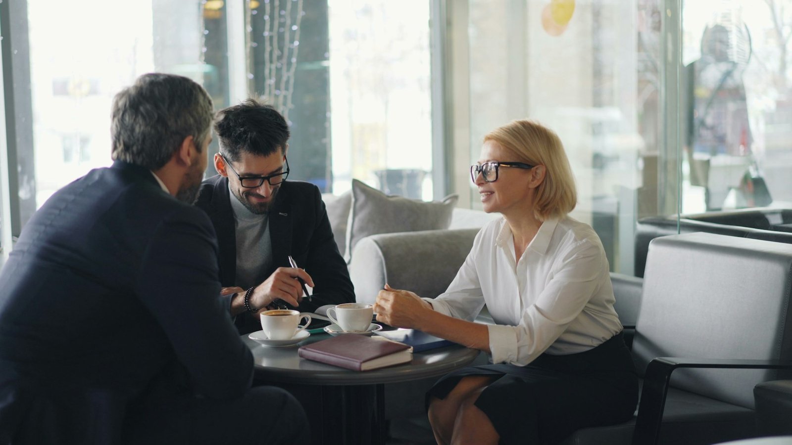 Attorneys in conversation with a client at a table